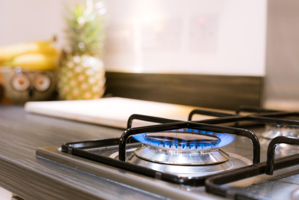 Blue flame burning on a residential gas stove, illustrating proper gas line function and the importance of regular gas line inspections for home safety.